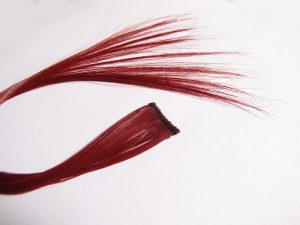 Clip of red hair to wear in natural hair for a more daring look.